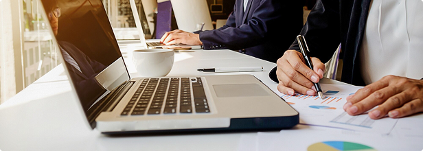 Professional reviewing charts and documents at a desk
